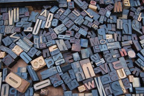 Wooden letter stamps scattered on the floor.