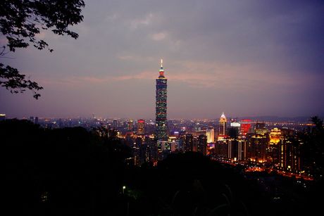 Taipei 101 illuminated at sunset.